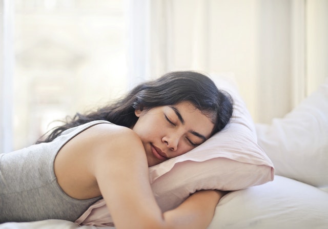 A woman sleeping well to promote her immune system as suggested by allergy doctor in Darwin