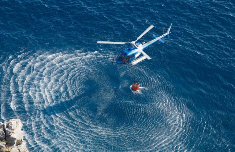 A rescue helicopter hovering over water